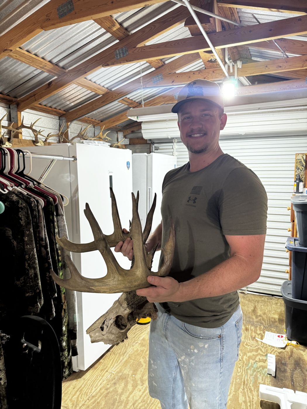 Truett holding a deer (owner photo)